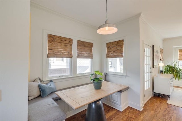 dining room featuring breakfast area, crown molding, and hardwood / wood-style flooring