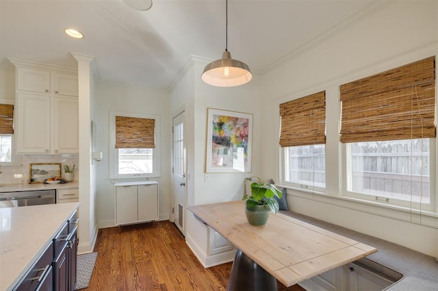 interior space with hardwood / wood-style floors, crown molding, a wealth of natural light, and breakfast area