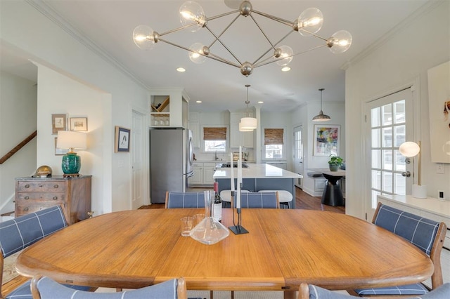 dining room with ornamental molding and light wood-type flooring