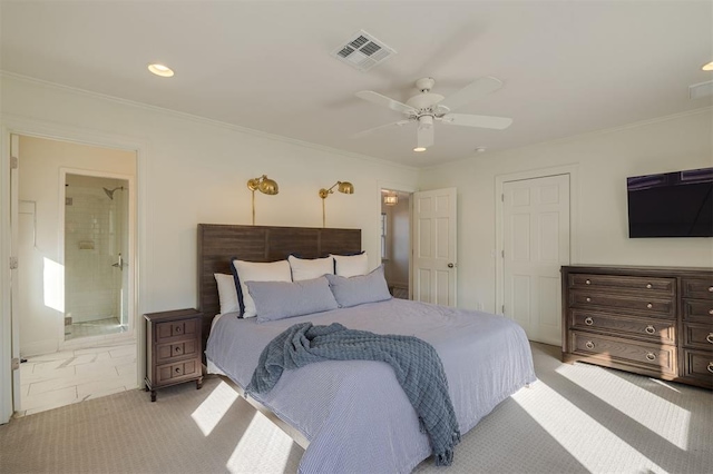 carpeted bedroom with ornamental molding, ensuite bathroom, and ceiling fan