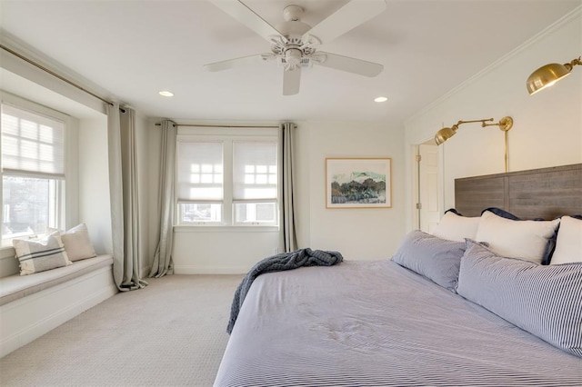 carpeted bedroom featuring crown molding and ceiling fan