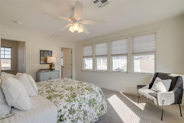 bedroom featuring multiple windows, carpet floors, and ceiling fan