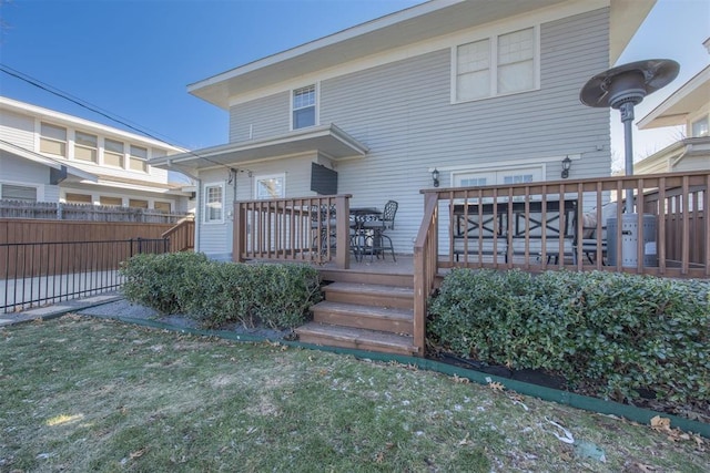 back of house with a yard and a deck