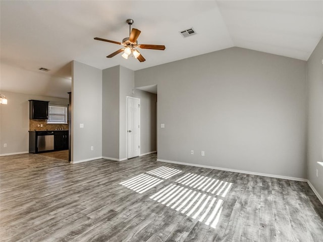 unfurnished living room with lofted ceiling, dark hardwood / wood-style flooring, and ceiling fan