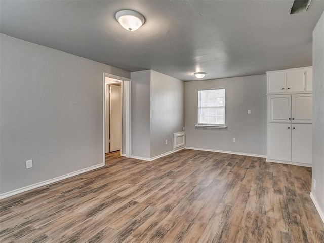 empty room featuring wood-type flooring