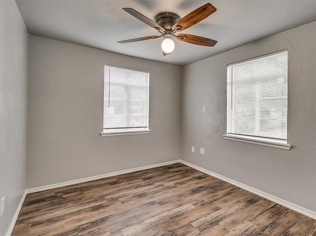 empty room with hardwood / wood-style floors and ceiling fan