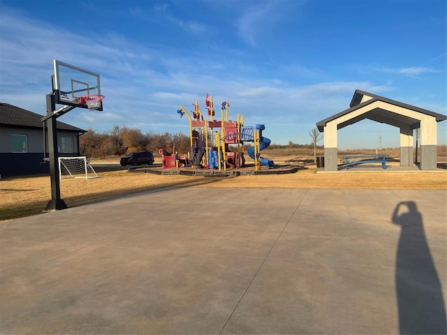 view of playground featuring basketball hoop