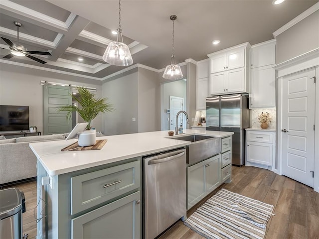 kitchen featuring coffered ceiling, sink, a center island with sink, appliances with stainless steel finishes, and white cabinets