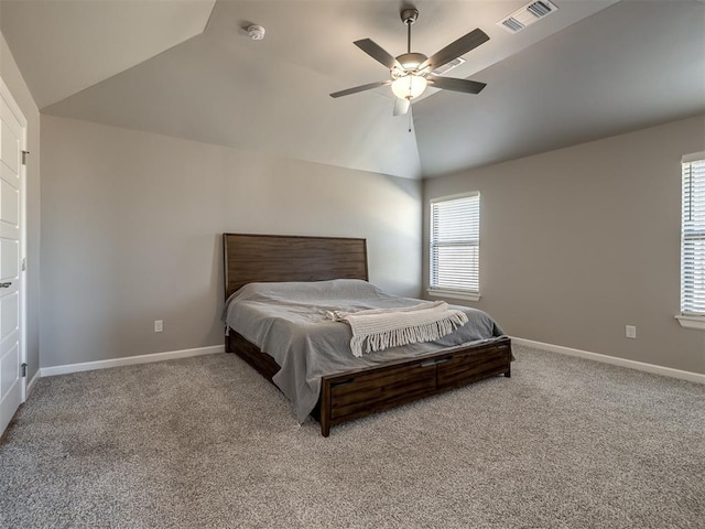 carpeted bedroom with ceiling fan and vaulted ceiling