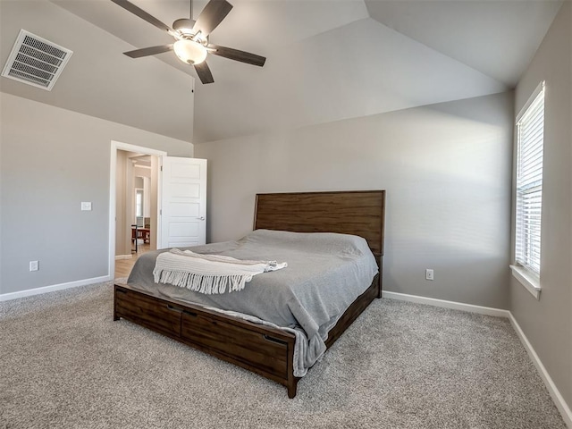 bedroom featuring ceiling fan, vaulted ceiling, and light carpet