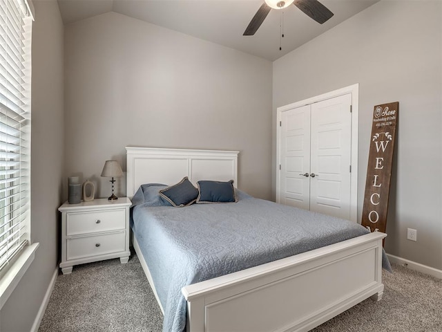 bedroom with lofted ceiling, light colored carpet, a closet, and ceiling fan