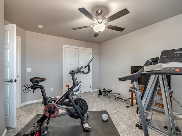 exercise room with ceiling fan and carpet