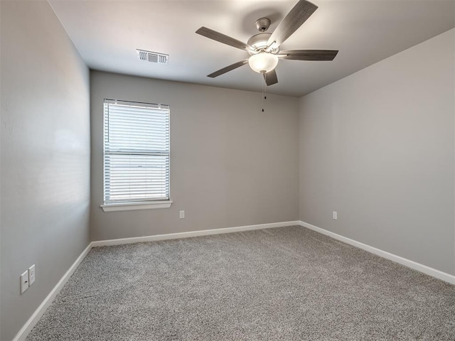 unfurnished room featuring ceiling fan and carpet