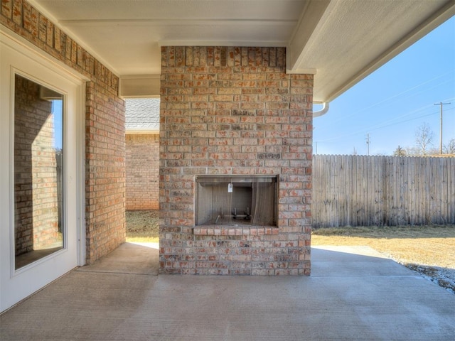 view of patio with an outdoor brick fireplace