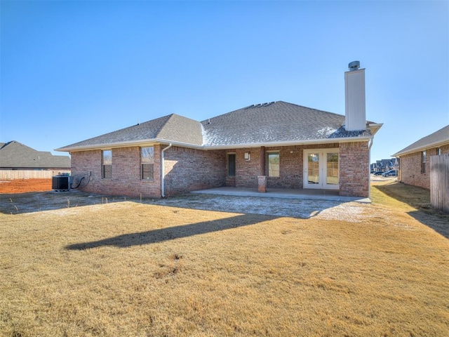 back of house featuring a yard, a patio area, and central air condition unit