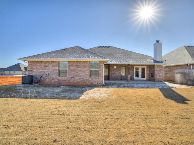 rear view of house featuring a yard, central AC, a patio area, and french doors