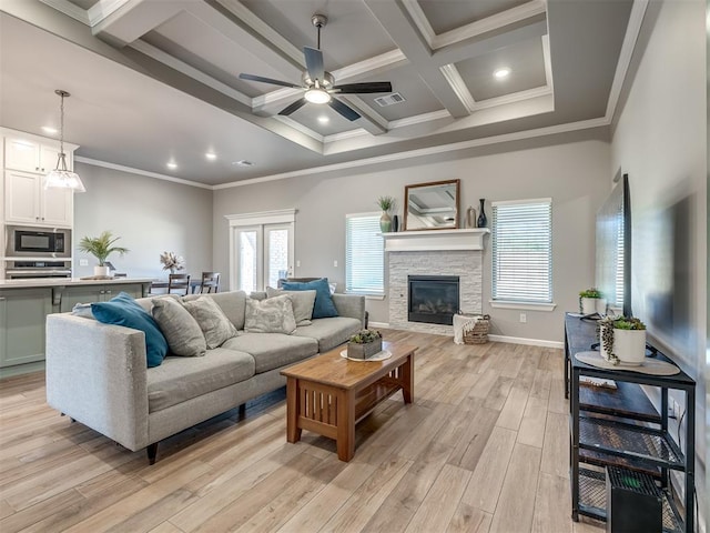 living room with a fireplace, beamed ceiling, ornamental molding, coffered ceiling, and light hardwood / wood-style floors