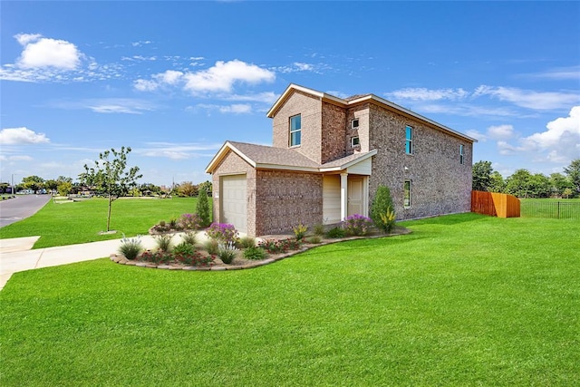 view of front of property featuring a garage and a front yard