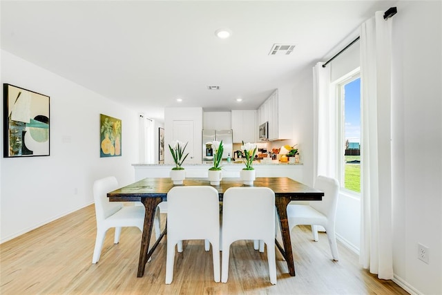 dining room with light hardwood / wood-style floors