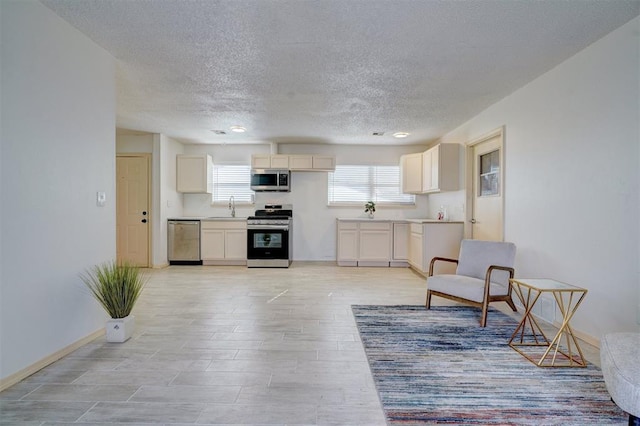 living room featuring sink and a textured ceiling