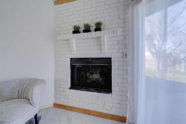 details featuring hardwood / wood-style flooring and a fireplace