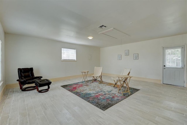 living area with light hardwood / wood-style flooring and a wealth of natural light