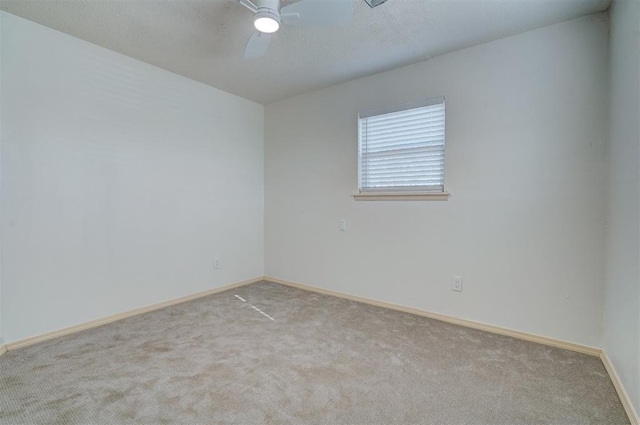 unfurnished room with light colored carpet and ceiling fan