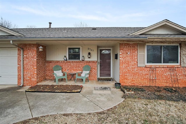 doorway to property with a garage