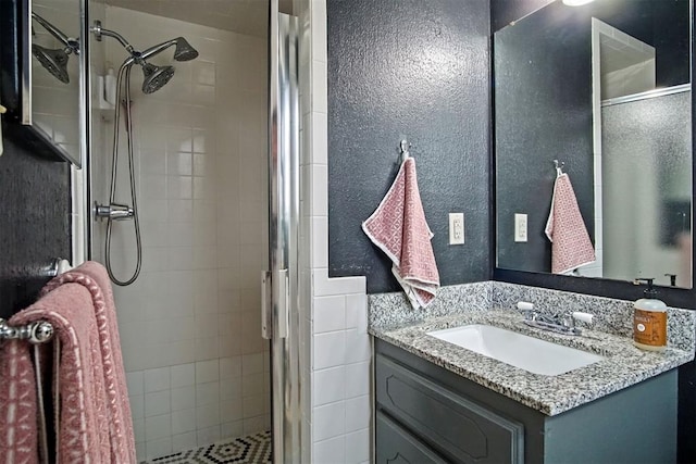 bathroom with vanity and a shower with shower door