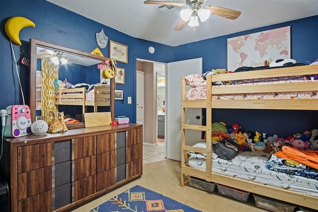 carpeted bedroom featuring ceiling fan and a textured ceiling