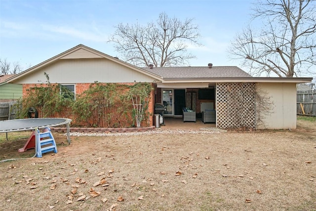 back of house featuring a trampoline