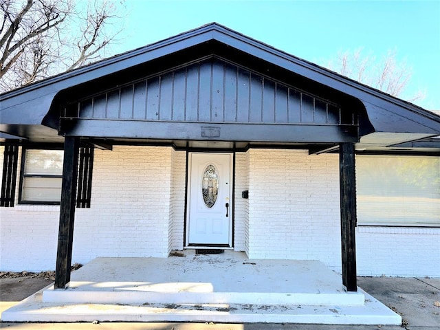 view of exterior entry with covered porch