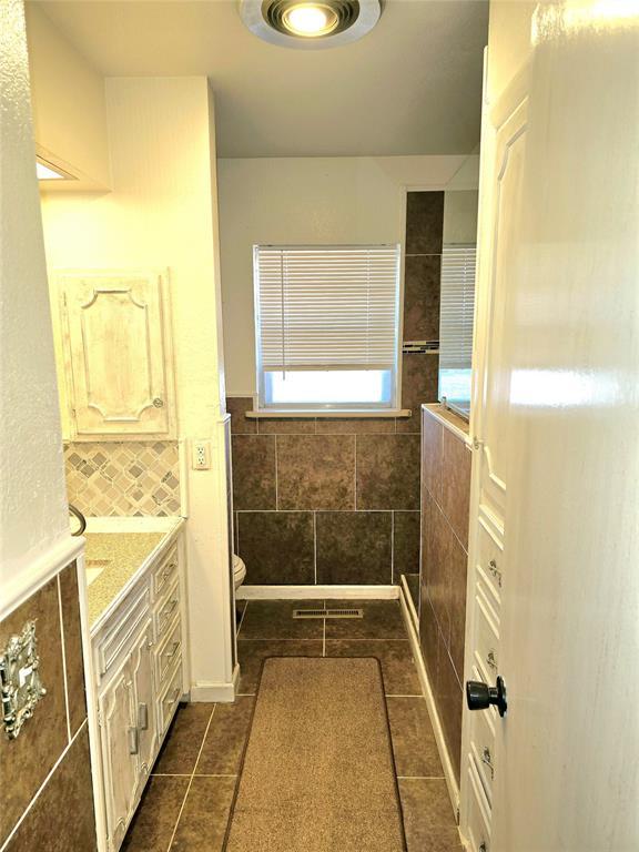 bathroom with vanity, tile patterned floors, and toilet