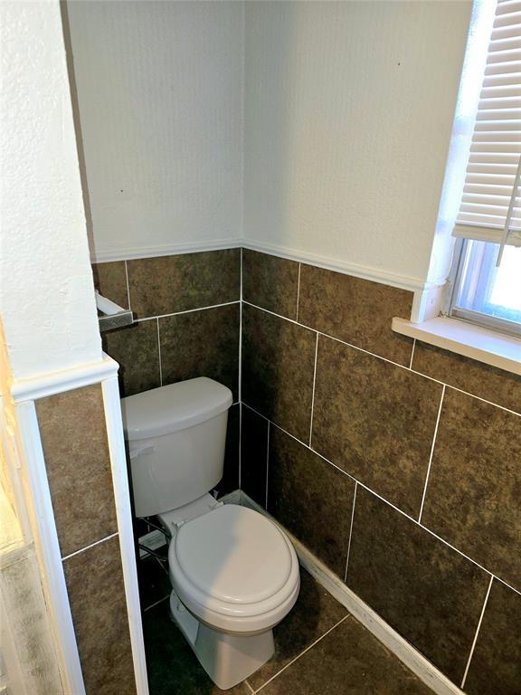 bathroom with tile patterned flooring and toilet