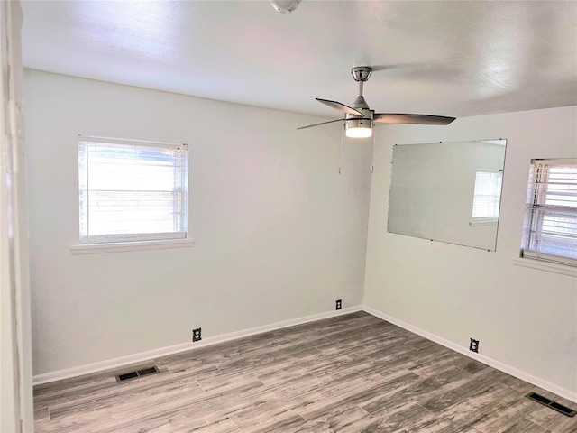 spare room with ceiling fan and wood-type flooring