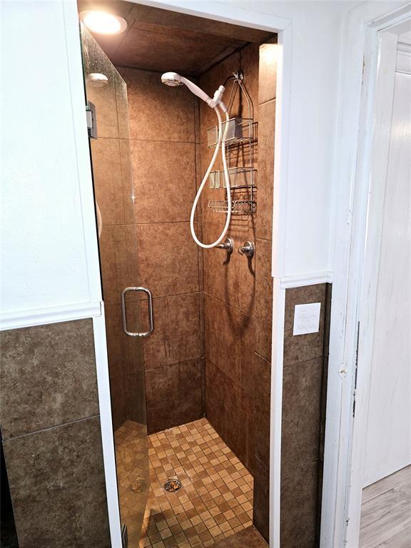 bathroom featuring an enclosed shower