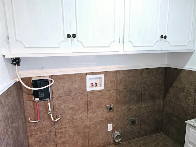 washroom featuring cabinets, hookup for an electric dryer, and hookup for a washing machine