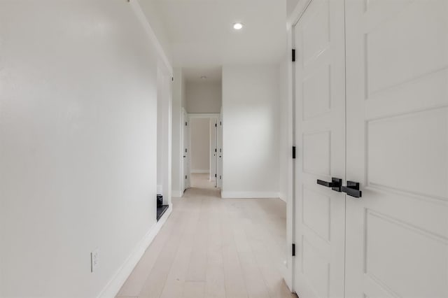 corridor with light wood-type flooring