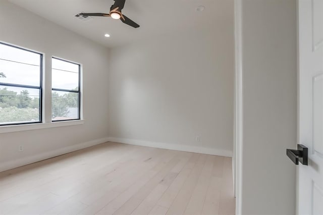 spare room with ceiling fan and light wood-type flooring