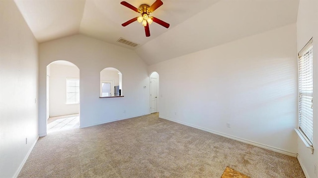 unfurnished room with lofted ceiling, light colored carpet, and ceiling fan