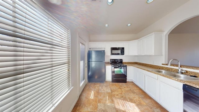 kitchen with white cabinetry, sink, and black appliances