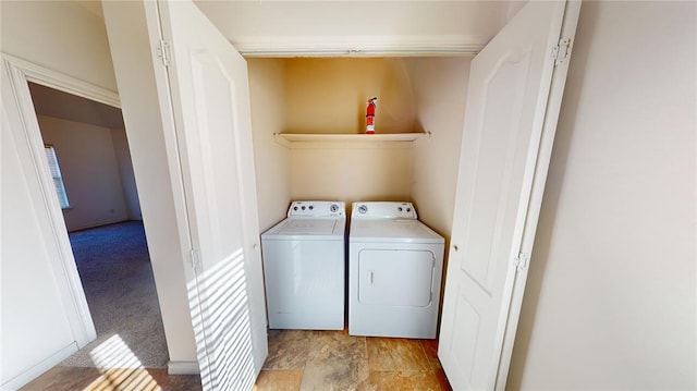 washroom with independent washer and dryer and light carpet