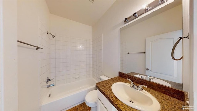 full bathroom with vanity, tiled shower / bath combo, and toilet