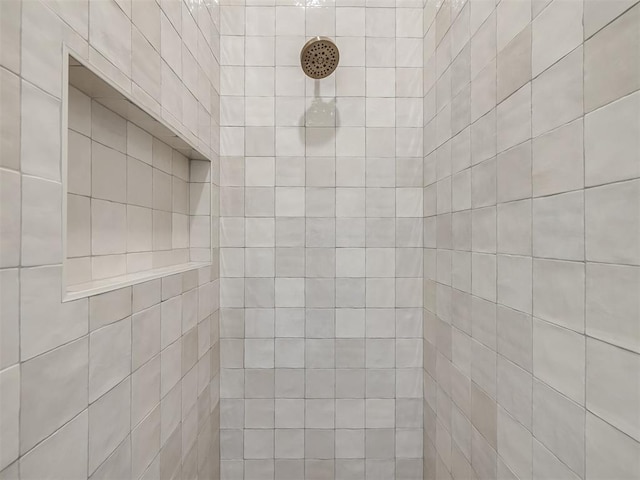 bathroom with a tile shower