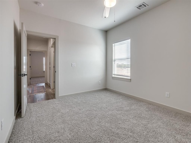 unfurnished room with ceiling fan and carpet flooring