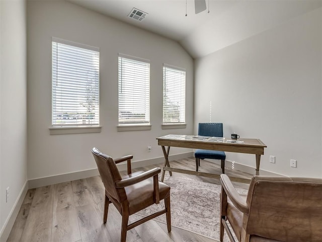 office space featuring vaulted ceiling, ceiling fan, and light hardwood / wood-style floors