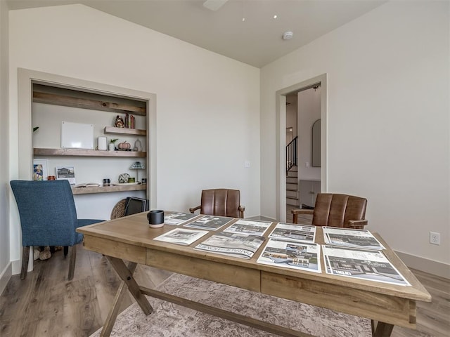 dining area with hardwood / wood-style floors, built in features, and ceiling fan