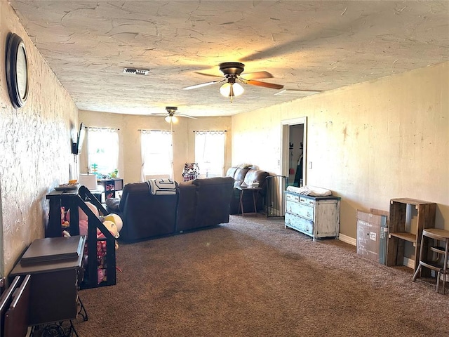 living room with dark colored carpet, plenty of natural light, and ceiling fan