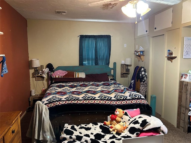 bedroom featuring carpet, ceiling fan, and a closet