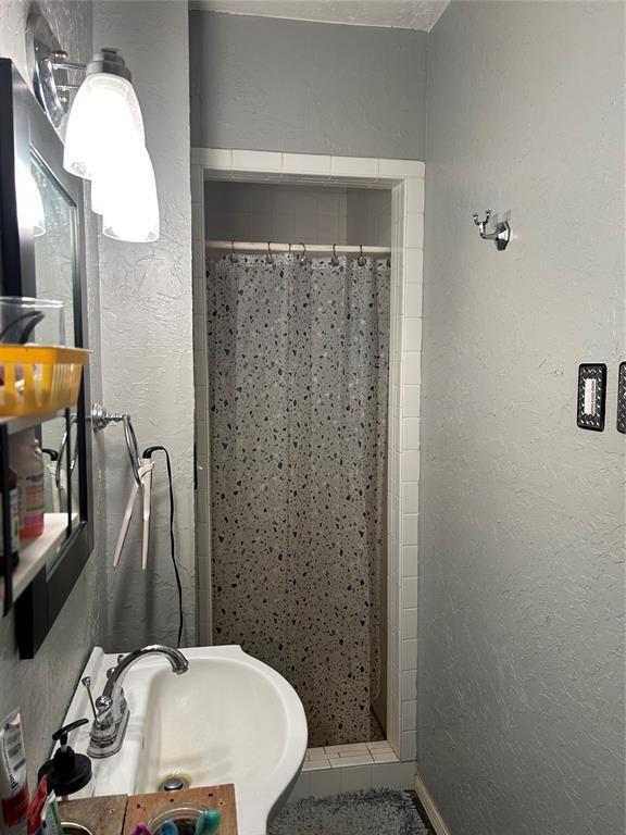 bathroom featuring sink and walk in shower